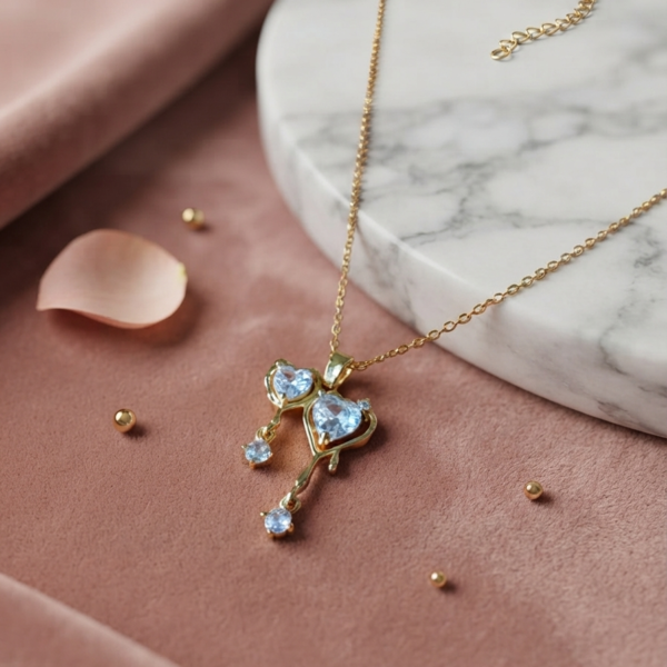 Gold chain with light blue heart pendant