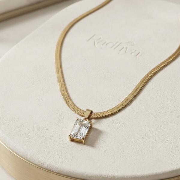 Golden snake chain with emerald-cut pendant