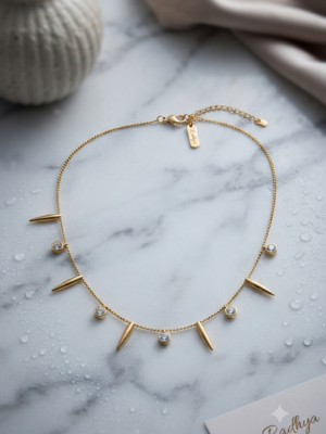 Gold chain with spiked and stone charms