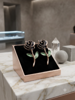 Charming black rose earrings with green leaves.